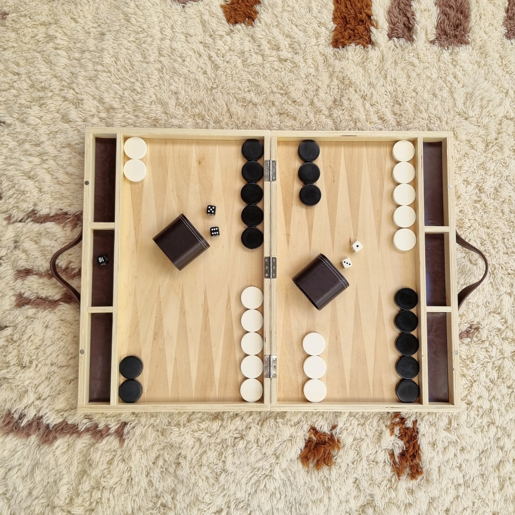 playing backgammon on the floor, at home with earth toys in cairns