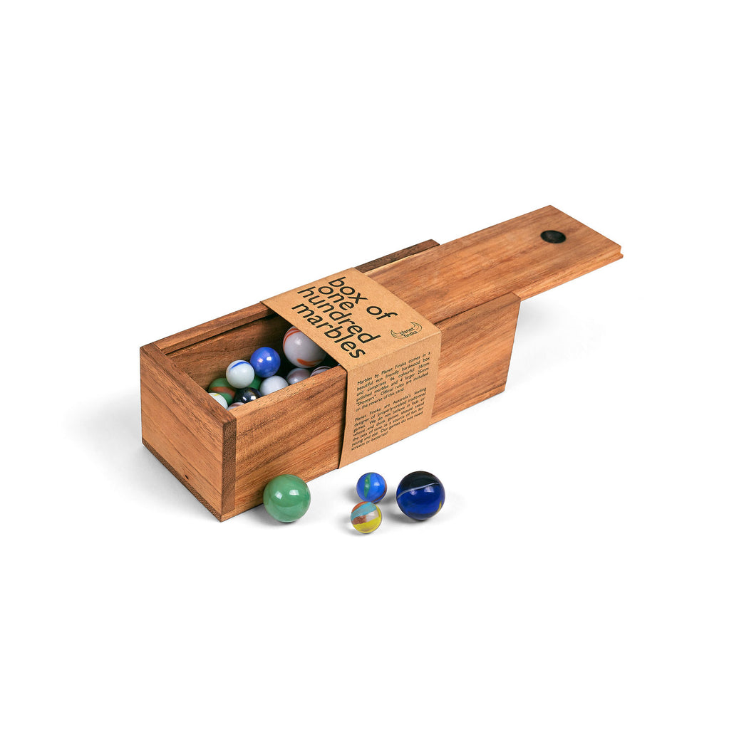 wooden box of colourful glass marbles open