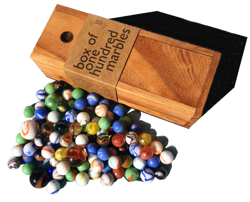 wooden box of colourful glass marbles with marbles outside the box