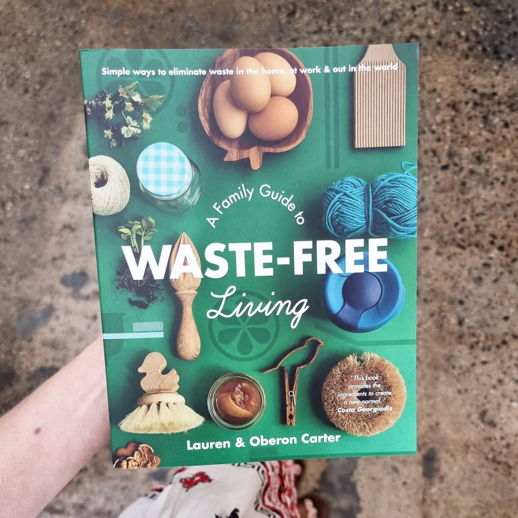 bree holding a copy of "a family guide to waste free living" by lauren and overson carter in-store