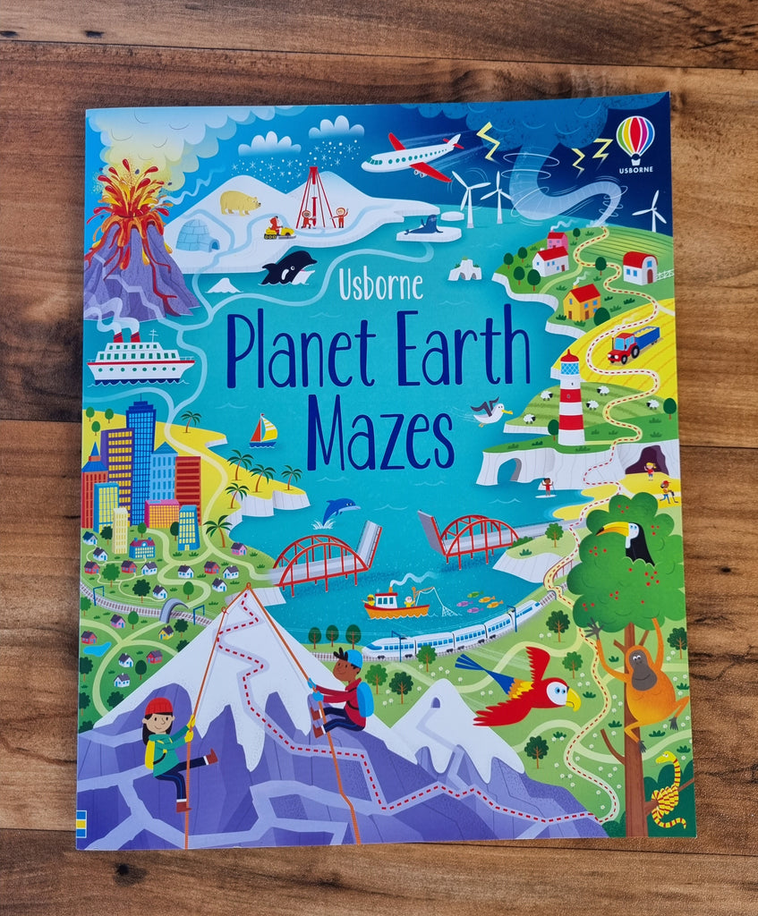 planet earth mazes usborne activity book on wood background